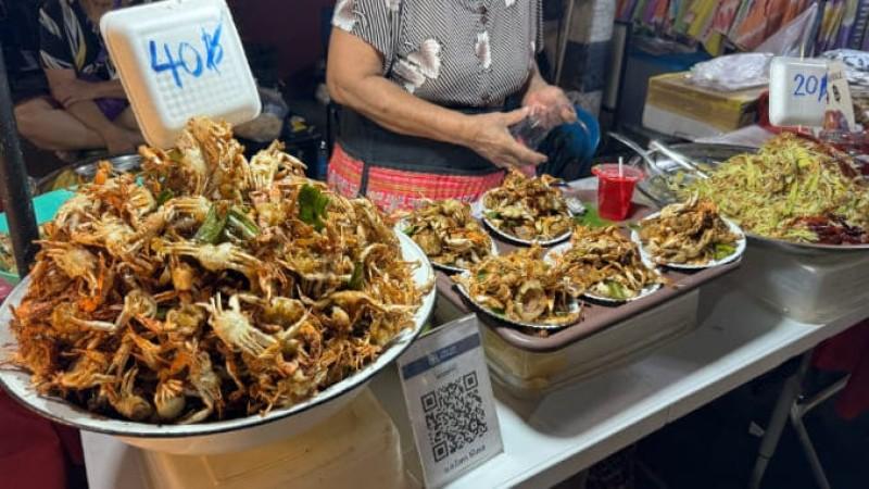 Sampling street foods at Aranyaprathet Night Market - © Paste Magazine