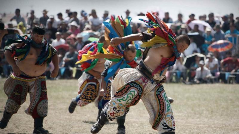 Wrestlers perform the eagle dance before a wrestling competition during the Naadam Festival in Xilin Gol League